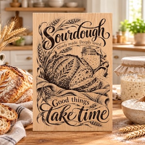 May include: A rectangular wooden sign featuring a dark brown engraved illustration of a sourdough loaf, wheat stalks, and a glass jar. The text reads: Sourdough, Slowly made. Deeply loved. Good things take time, in a decorative script.