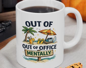 May include: A white ceramic mug featuring a colorful beach scene illustration with a palm tree, beach umbrella, flip-flops, and a drink. The text reads OUT OF OUT OF OFFICE MENTALLY. The mug has a handle and is filled with a dark liquid.