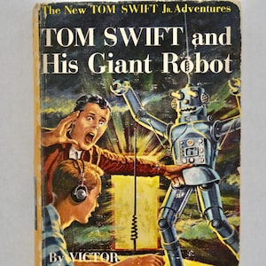 May include: Vintage book cover for "Tom Swift and His Giant Robot." The cover features a retro illustration of a robot, a boy with headphones, and another boy with a shocked expression. The title and author's name are displayed prominently.