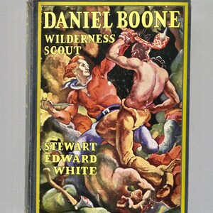 May include: A hardcover book titled Daniel Boone Wilderness Scout by Stewart Edward White. The cover features a colorful illustration of two figures in a physical struggle, with yellow text set against a dark, textured background.