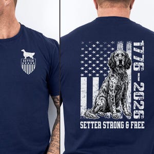 May include: Navy blue t-shirt featuring a white graphic of an English Setter dog and the text "SETTER" inside a shield. The back of the shirt displays an American flag design with a seated Setter and the text "1776-2026 SETTER STRONG & FREE."