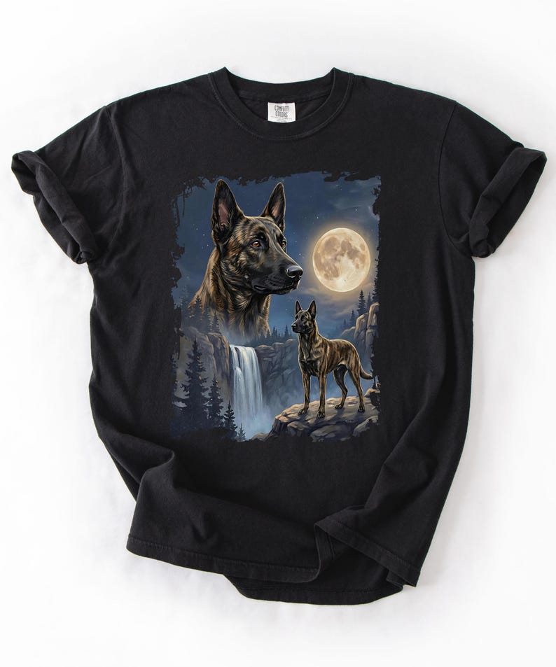 May include: Black t-shirt featuring a detailed illustration of two dogs, one a close-up of the head and the other standing on a rock. The background includes a waterfall, trees, and a full moon.