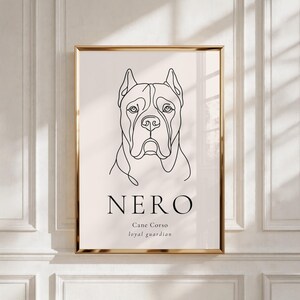 May include: A framed art print with a minimalist line drawing of a Cane Corso dog. The artwork is in black against a cream background, with the name "NERO" and the words "loyal guardian" below the dog's image. The frame is gold.