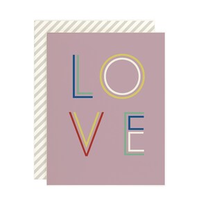 May include: A pink card with the word "LOVE" written in colorful, geometric letters.