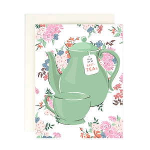 May include: A green teapot and teacup with a floral pattern on a white background. The teapot has a tag that says "Glad we're best-teas".