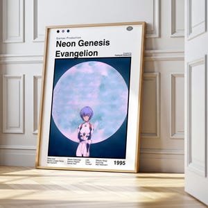 May include: A framed poster featuring the text "Neon Genesis Evangelion" with an illustration of a character in front of a large, blue-toned moon. The poster is in a wooden frame and leans against a white wall.