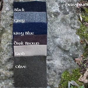 May include: Six fabric swatches of heavy weight wool in the colors black, grey, navy blue, dark brown, sand, and olive.