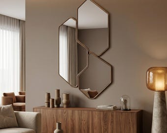 May include: A wall-mounted mirror set consisting of three interconnected, irregular hexagonal shapes with thin metallic frames. The reflective surfaces are arranged in a vertical cluster, creating a geometric composition on the wall.