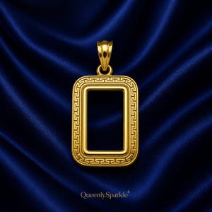 May include: A rectangular gold pendant featuring a polished finish and a detailed Greek key pattern border. The pendant includes a sturdy top bail for attachment, showcasing a clean, open center design with a bright, reflective metallic surface.