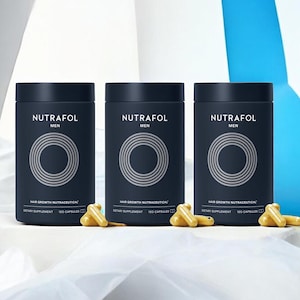 May include: Three dark blue cylindrical bottles of Nutrafol Men hair growth nutraceuticals, with a silver circular design. Several yellow capsules are scattered in front of the bottles. A small blue and silver can is also visible.