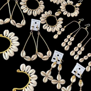 May include: An assortment of gold-toned earrings featuring natural seashells. Styles include hoop, teardrop, and dangle designs, with the shells arranged in various patterns. The earrings are displayed against a black background.