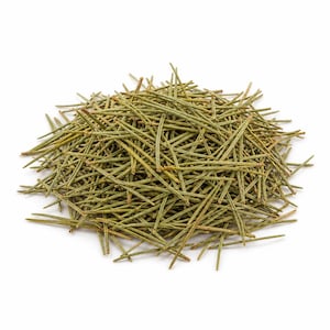 May include: A pile of dried, green pine needles against a white background. The needles are slender and vary in length, with a slightly yellowish hue at the tips. The overall texture appears dry and brittle, suggesting they are for crafting or decorative purposes.