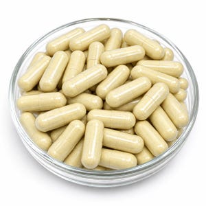 May include: A clear glass bowl filled with numerous light beige, cylindrical capsules. Each capsule features a smooth, two-piece design with a visible seam in the center, containing a fine, powdery substance inside the translucent shell.
