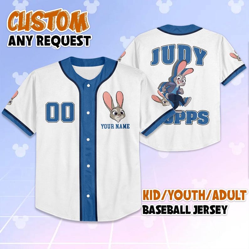 May include: White baseball jersey with blue trim and buttons. Features a cartoon rabbit graphic and the text "YOUR NAME" below it. The jersey also has the number "00" on the front and "JUDY HOPPS" on the back. The text "CUSTOM ANY REQUEST" is at the top.