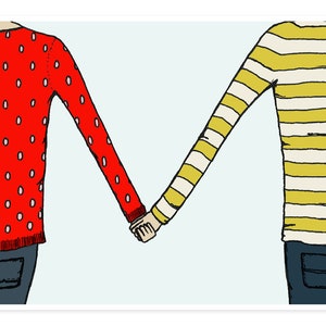 May include: Two people holding hands, one wearing a red sweater with white polka dots and the other wearing a yellow and white striped sweater.