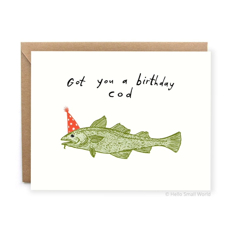 May include: A white card with the text "Got you a birthday cod" written in black marker. A green cartoon fish with a red and white party hat is drawn on the card.