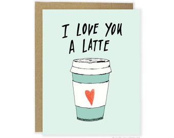 May include: A light blue and white coffee cup with a red heart on the side. The text "I love you a latte" is written in black above the cup.