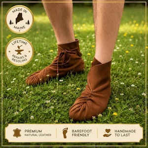 May include: A pair of brown leather ankle boots with a soft, gathered toe construction and a side lace-up closure. The boots feature a flexible design that contours to the foot, with visible stitching details along the front and a smooth, matte finish.