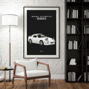May include: Framed print featuring a white sports car illustration against a black background. The text "MINIMAL AUTOMOTIVE SERIES" is at the top, with "No. 4" at the bottom. The artwork is displayed in a room with a white brick wall.