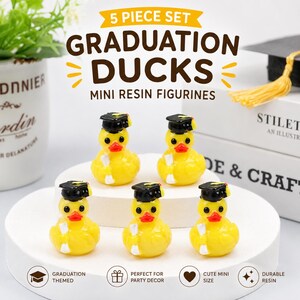 May include: A 5-piece set of yellow resin duck figurines, each wearing a black graduation cap and holding a white diploma. The text 5 PIECE SET GRADUATION DUCKS MINI RESIN FIGURINES is displayed above the ducks, with icons and text below.