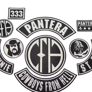 May include: A collection of black and white patches featuring the band name "Pantera" and related imagery. Includes patches with text like "Cowboys From Hell", "St. Vinnie", and "St. Dime", along with a "333" patch and band member portraits.