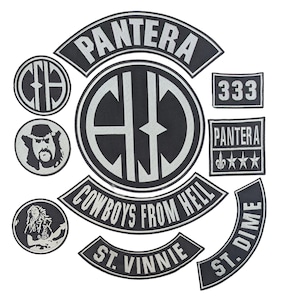 May include: A collection of black and silver patches featuring the band Pantera's logo and other related designs. The patches include the band's name, the phrase "Cowboys From Hell," and other graphics. The patches are likely for clothing or accessories.