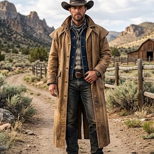 May include: A person wearing a brown cowboy hat, a long brown leather coat, a denim jacket, and blue jeans. The person is standing on a dirt path in front of a wooden fence and a barn. The background features mountains and a cloudy sky.