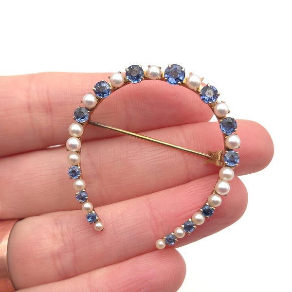 Broche antiguo victoriano de oro de 14 quilates con zafiro azul y perlas en forma de herradura. Joyería de la suerte.