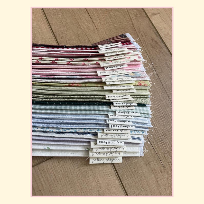May include: A stack of folded fabric squares in various colors and patterns, including gingham, floral, and solid prints. Each piece of fabric features a small white fabric tag attached to the edge with the text Peony Projects printed on it.