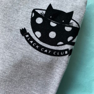 Black Cat Club Woman's Heather Grey top with teacup and paw prints. Ladies T-Shirt. Cat Lover image 2