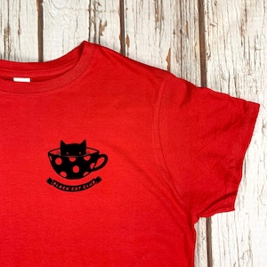 Black Cat Club Woman&#39;s red top with teacup and paw prints. Ladies T-Shirt.