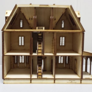 May include: A wooden dollhouse with four levels, showing the interior of each room. The dollhouse has a staircase, windows, and a porch.