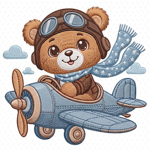 May include: Embroidered image of a brown teddy bear wearing a pilot's helmet and scarf, flying a blue airplane. The bear has large eyes and a smiling expression. The airplane has a propeller and wheels, with blue clouds in the background.