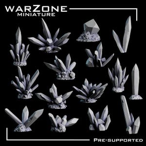 May include: A collection of gray miniature crystal formations, varying in size and shape, against a black background. The crystals have sharp, geometric facets and are mounted on textured bases. The text "WARZONE MINIATURE" and "PRE-SUPPORTED" are visible.