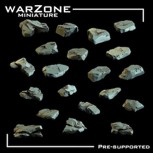 May include: A collection of eighteen individual light grey rock miniatures arranged on a black background. The text WARZONE MINIATURE is at the top left, and the text PRE-SUPPORTED is at the bottom right. Each rock has a jagged texture.