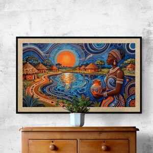 May include: A framed art print depicting an African village scene. The artwork features a woman holding a vase, with a sunset over a lake and huts in the background. The color palette includes blues, oranges, and browns.