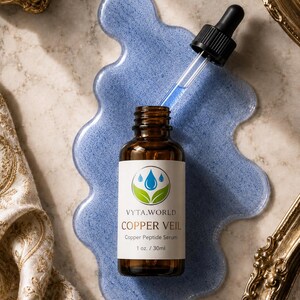May include: An amber glass bottle of Vyta.World Copper Veil Copper Peptide Serum, 1 oz. / 30ml, with a black dropper cap. The bottle sits on a blue, translucent, irregular-shaped puddle of serum, with a glass dropper extended above the bottle.