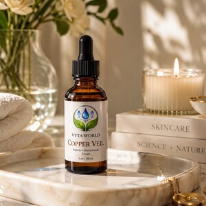May include: An amber glass dropper bottle of Vyta World Copper Veil Peptide + Niacinamide Serum. The white label features a blue water drop and green leaf logo, with text reading 1 oz / 30 ml. The bottle has a black dropper cap and sits upright.