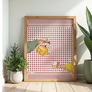 May include: Framed art print featuring a patterned background in red and white. The artwork depicts a yellow teapot pouring tea into a glass held by a person. The image is set in a wooden frame.
