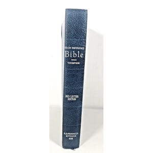 May include: A blue Bible with the text "Chain Reference Bible" and "Thompson" printed in white. The words "Red Letter Edition" are also visible. The book is a B.B. Kirkbride edition, Riverside 408.