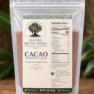 May include: A clear, resealable pouch containing brown cacao powder. The label features the text Centro Metsa Noma, Cacao Ceremonial Grade, From the Heart of the Amazon, Pucallpa, Peru, and a nutrition facts panel. Net weight is 10 oz (283 g).