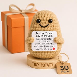 May include: A tan crocheted potato figure with black bead eyes and a stitched smile, holding a white card that reads: In case I don't say it enough, here's a tiny potato to remind you: you're Sexy, beautiful, and strong. I appreciate you. And I love you.