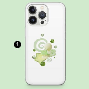 May include: White phone case with a green and white illustration. The design features a small, round figure using a laptop, surrounded by green clovers and swirls. The number "1" is in a black circle in the upper left corner.