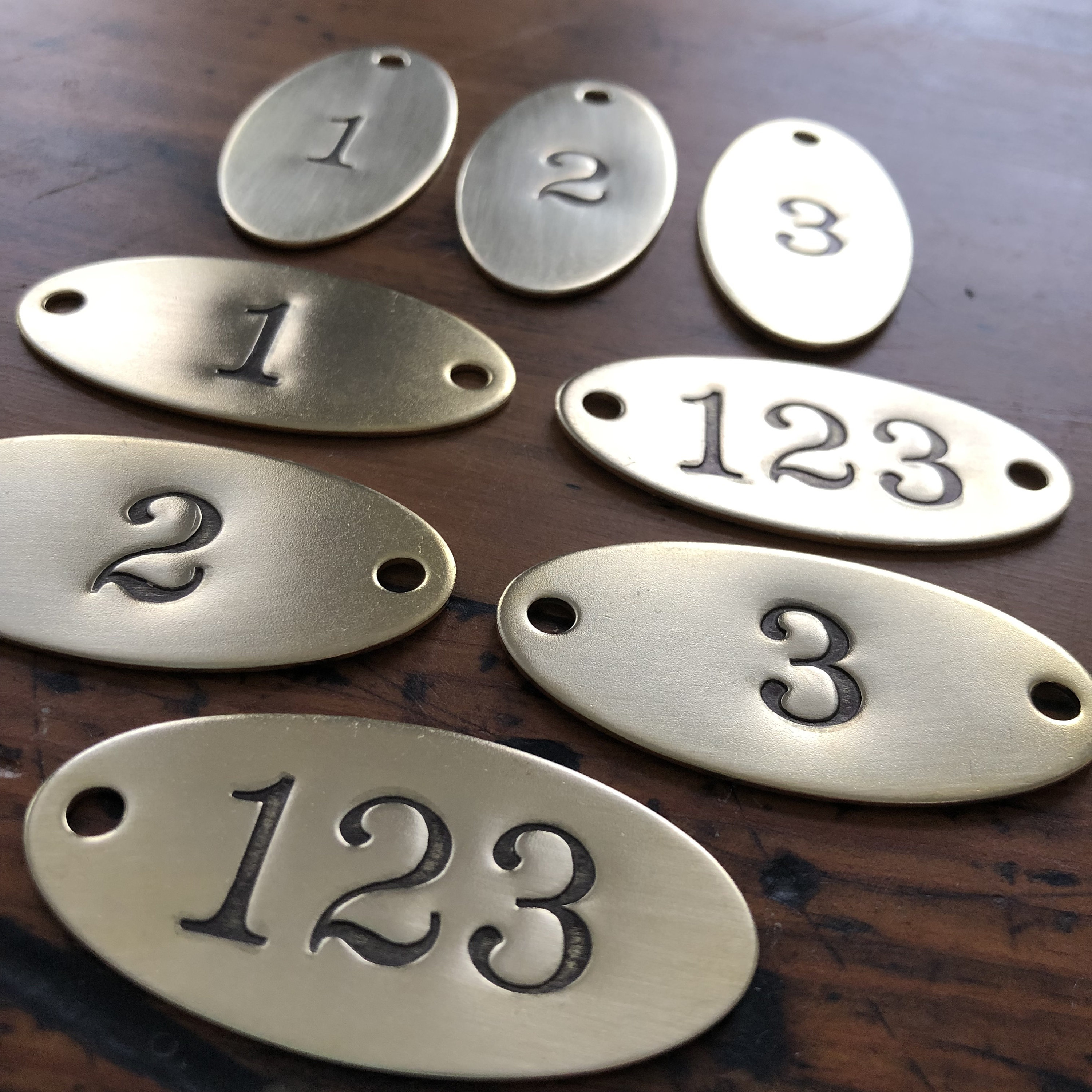 Hand punched brass Oval numbered tags Custom numbered locker tags
