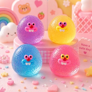 May include: Four colorful, textured, egg-shaped toys with cartoon faces. The toys are purple, yellow, blue, and pink. The toys have red noses, yellow eyes, and white teeth. The background includes a rainbow, clouds, and the text "Have a cute day!"