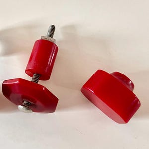 Two vintage red bakelite cabinet or drawer knobs (circa 1930-1940)