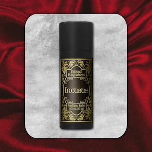May include: A black tube with a gold label that reads "Fabled Fragrances" and "Incubus Parfum Balm 0.5 oz (15 g)".