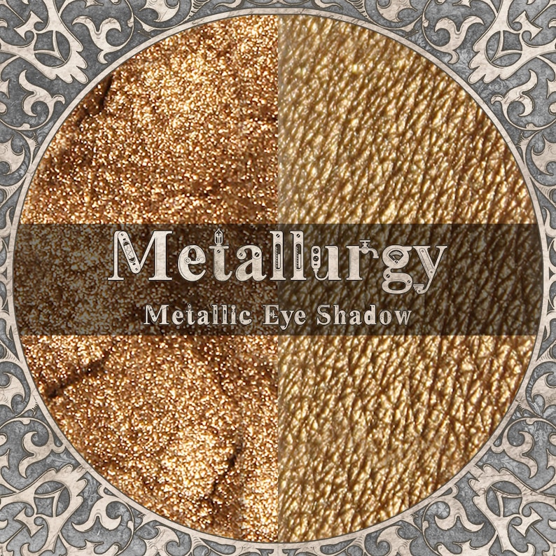 May include: A circular display of Metallurgy metallic eye shadow featuring a split-screen view of a loose, shimmering gold powder on the left and a smooth, applied gold pigment swatch on the right, framed by an ornate, grey filigree border.