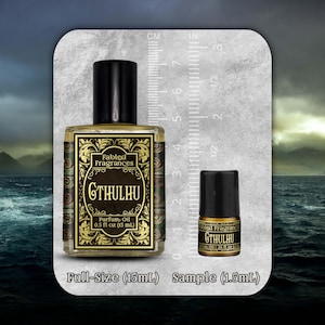 May include: A rectangular glass bottle of Fabled Fragrances Cthulhu parfum oil with a black cap, labeled 0.5 fl oz (15 mL), alongside a small sample vial labeled 0.05 fl oz (1.5 mL), both positioned next to a ruler showing metric and imperial scales.