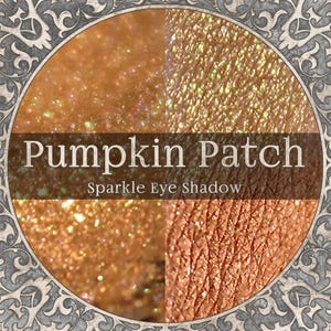 May include: A close-up of a four-part eye shadow palette with the text "Pumpkin Patch Sparkle Eye Shadow." The palette features shimmering shades of orange, gold, and bronze. The eye shadow has a glittery, sparkling finish, ideal for creating a glamorous look.